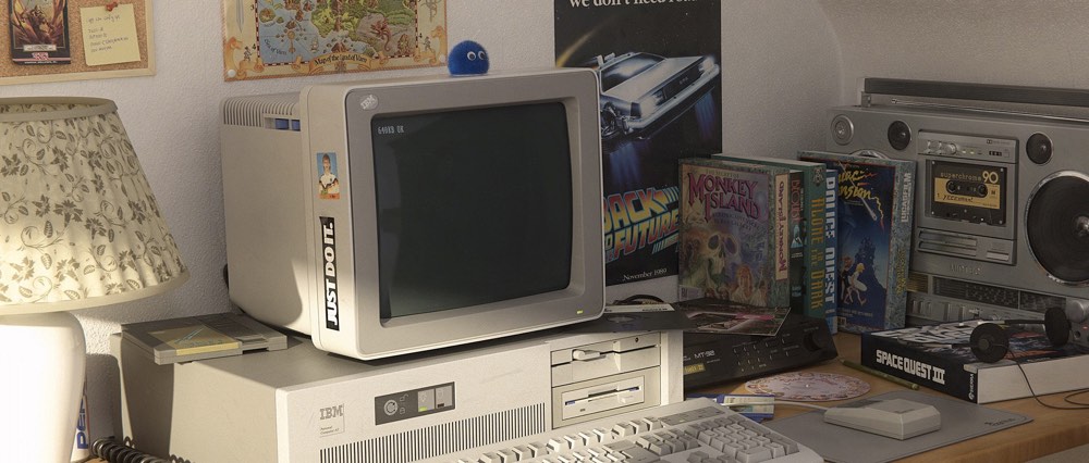 computer from the 90s on a desk with lots of 90s memorabilia