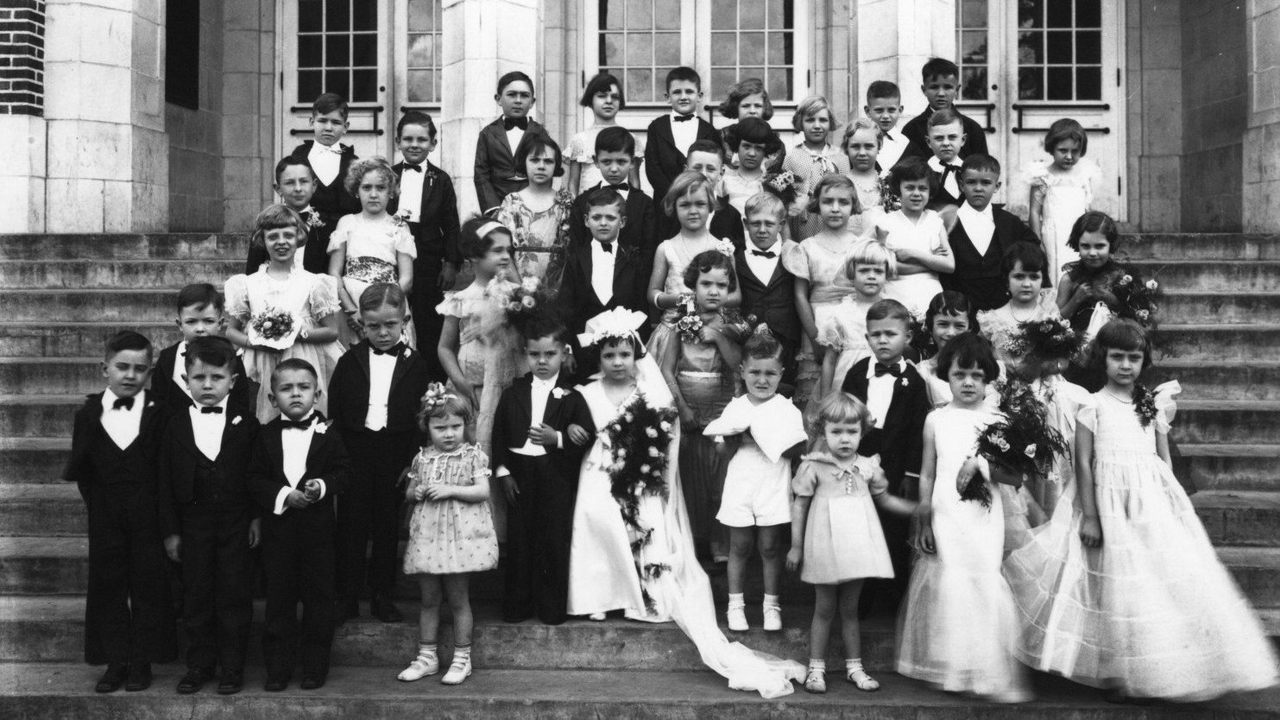 old Black and white photo of a pretend wedding with young children acting as adults
