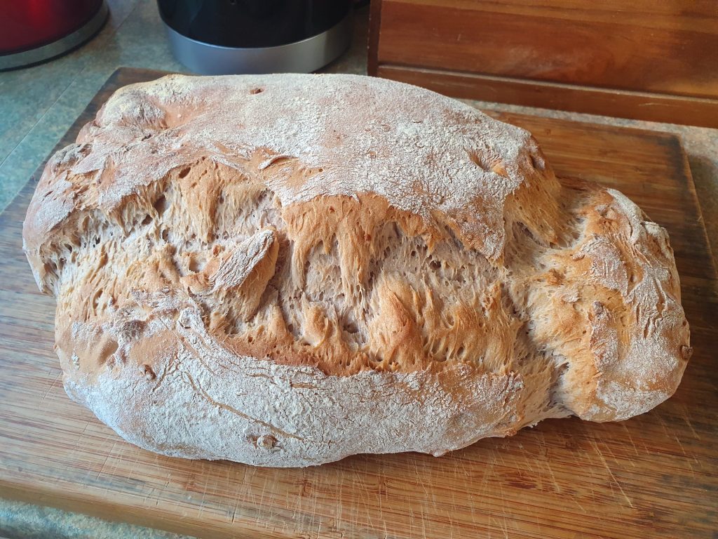 whole hazelnut bread, just out of the oven on a wood board